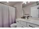 Bathroom with a white vanity, modern fixtures, and a shower curtain at 9836 Banner Peak St, Littleton, CO 80125