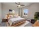Stylish bedroom with a large window and modern decor featuring a comfortable bed and bedside tables at 9836 Banner Peak St, Littleton, CO 80125