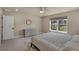 Bright bedroom with neutral tones, features a ceiling fan, dresser, and window view of the neighborhood at 9836 Banner Peak St, Littleton, CO 80125