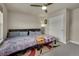 Bedroom with a large window and ceiling fan features two beds and a colorful rug at 9836 Banner Peak St, Littleton, CO 80125