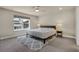Comfortable bedroom with a large window, ceiling fan, and carpeted floor, providing a tranquil retreat at 9836 Banner Peak St, Littleton, CO 80125