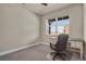 Well-lit bedroom featuring a neutral color palette, desk, and a large window, offering ample natural light at 9836 Banner Peak St, Littleton, CO 80125