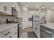 Modern kitchen featuring white cabinets, stainless steel appliances, a gas range, and sleek countertops at 9836 Banner Peak St, Littleton, CO 80125