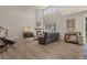 Bright living room with vaulted ceilings, fireplace, and wood-look floors creating a comfortable atmosphere at 9836 Banner Peak St, Littleton, CO 80125