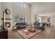 Inviting living room and dining area with high ceilings and fireplace, great for gatherings and comfort at 9836 Banner Peak St, Littleton, CO 80125