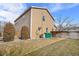 A house's exterior and backyard featuring a lawn, fence, and trees on a sunny day at 873 Mockingbird St, Brighton, CO 80601