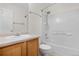 Bright bathroom featuring a white vanity, toilet, and tiled tub-shower with updated fixtures at 873 Mockingbird St, Brighton, CO 80601