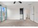 Bedroom featuring neutral carpet, large window with curtains, closet and crisp white paint at 873 Mockingbird St, Brighton, CO 80601