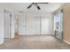 Bright bedroom featuring neutral carpet, closet, and light-filled windows with blue curtains at 873 Mockingbird St, Brighton, CO 80601