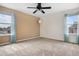 Bright bedroom with neutral carpet, ceiling fan, two windows with curtains and fresh paint at 873 Mockingbird St, Brighton, CO 80601