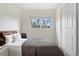 Bedroom with a plush bed, closet, and a window providing natural light at 873 Mockingbird St, Brighton, CO 80601