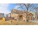 Charming two-story home featuring an attached two-car garage and a well-maintained front yard at 873 Mockingbird St, Brighton, CO 80601