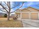 A charming home exterior with a well-manicured lawn, garage, and mature trees at 873 Mockingbird St, Brighton, CO 80601