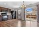 Modern kitchen with wood floors, stainless steel appliances, and a sliding glass door to the outdoor deck at 873 Mockingbird St, Brighton, CO 80601