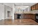 Open kitchen view featuring wood floors, granite counters, modern appliances and a mosaic tile backsplash at 873 Mockingbird St, Brighton, CO 80601