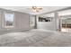 Bright living room with two large windows offering a view of the outside and connecting to the kitchen at 873 Mockingbird St, Brighton, CO 80601