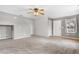 Spacious living room featuring a ceiling fan, a front door, and plush carpet, offering comfort at 873 Mockingbird St, Brighton, CO 80601