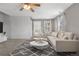 Bright living room with neutral tones, a ceiling fan, and ample natural light at 873 Mockingbird St, Brighton, CO 80601