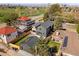 Expansive aerial view of the property featuring a modern home, lush landscaping, and a detached garage with solar panels at 2610 N Monroe St, Denver, CO 80205
