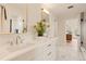 This bathroom boasts double sinks, a quartz countertop, modern fixtures, and tile floors at 2610 N Monroe St, Denver, CO 80205