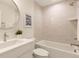 Bright bathroom featuring a tub and shower combo with decorative tiles, modern fixtures, and a stylish vanity at 2610 N Monroe St, Denver, CO 80205