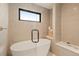 Serene bathroom showcasing a soaking tub, sleek fixtures, and natural light at 2610 N Monroe St, Denver, CO 80205