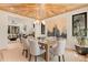 Open-concept dining room boasts a stylish ceiling, modern lighting, and natural light, flowing into the living space at 2610 N Monroe St, Denver, CO 80205