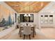 Bright dining room features a wooden ceiling, modern light fixture, and large windows with backyard views at 2610 N Monroe St, Denver, CO 80205