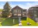 Stunning two-story home boasts a covered balcony, modern architecture, and a beautifully landscaped front yard at 2610 N Monroe St, Denver, CO 80205