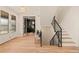 Bright foyer features hardwood floors, a staircase, and a doorway leading to an office space at 2610 N Monroe St, Denver, CO 80205