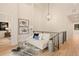 Upstairs hallway area decorated with a loveseat, glass table, and elegant lighting fixtures at 2610 N Monroe St, Denver, CO 80205