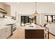 Bright, modern kitchen with marble countertops, stainless steel appliances, and stylish pendant lighting, and back door at 2610 N Monroe St, Denver, CO 80205
