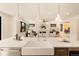 Bright kitchen boasts a large island with marble countertop and modern pendant lighting, opening into the living space at 2610 N Monroe St, Denver, CO 80205
