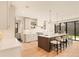 Open kitchen features island seating, modern lighting, stainless appliances, and easy access to the backyard at 2610 N Monroe St, Denver, CO 80205