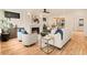 Bright living room features a cozy fireplace, hardwood floors, elegant furniture, and seamless flow into the dining area at 2610 N Monroe St, Denver, CO 80205