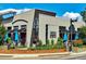 Exterior view of Cucina Colore restaurant featuring outdoor seating, blue umbrellas, and lush landscaping at 150 S Harrison St # 9, Denver, CO 80209