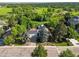 Aerial view of a home with solar panels, a well-manicured yard, and serene views of nearby green space at 9465 W 77Th Dr, Arvada, CO 80005