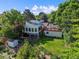 Spacious backyard features a lush lawn, mature trees, a fire pit area, and a storage shed at 9465 W 77Th Dr, Arvada, CO 80005