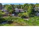 Expansive backyard with mature trees and lush landscaping, creating a private oasis near a creek at 9465 W 77Th Dr, Arvada, CO 80005