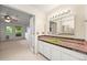 Unique bathroom features a colorful tile countertop and a green sink, adding a vibrant touch at 9465 W 77Th Dr, Arvada, CO 80005