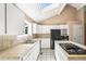 Clean kitchen featuring white cabinets, tiled backsplash, island cooktop and black appliances at 9465 W 77Th Dr, Arvada, CO 80005