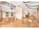 Open and airy living area with parquet floors, exposed beams, and many windows with natural light at 9465 W 77Th Dr, Arvada, CO 80005