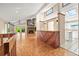 Open living area with parquet floors and stone fireplace, seamlessly connecting to the kitchen at 9465 W 77Th Dr, Arvada, CO 80005