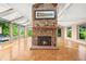 Spacious living room with stone fireplace, parquet floors, and many windows offering natural light at 9465 W 77Th Dr, Arvada, CO 80005