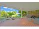 Covered back patio with a hot tub, fire pit, and ample seating area offering a relaxing outdoor retreat at 9465 W 77Th Dr, Arvada, CO 80005