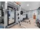 Personal gym in the basement with a weight rack and a full-length mirror at 19080 E Low Cir, Aurora, CO 80015