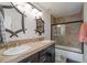 Well-lit bathroom featuring a double sink vanity and glass-enclosed shower at 19080 E Low Cir, Aurora, CO 80015