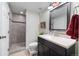 Bathroom featuring a walk-in shower and sleek vanity at 19080 E Low Cir, Aurora, CO 80015