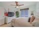 Bedroom with light green walls, a ceiling fan, and a large window with blinds at 19080 E Low Cir, Aurora, CO 80015