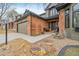 Inviting front entrance showcasing a well-maintained brick facade, stylish front door, and manicured flower beds at 19080 E Low Cir, Aurora, CO 80015